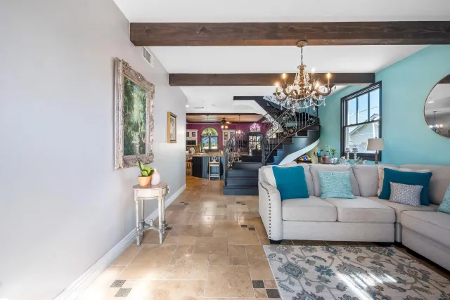 a living room with furniture and a chandelier