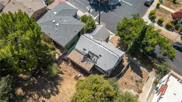 an aerial view of a house with outdoor space and street view
