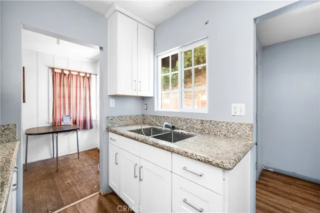 a kitchen with granite countertop a sink and a window