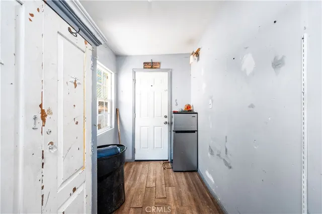 a view of a bathroom with walk in closet and wooden floor