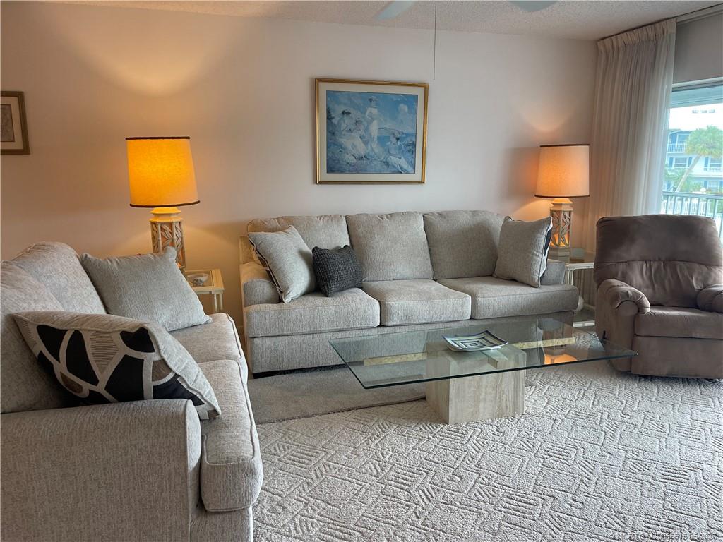 1858 Southwest Palm City Road, Unit 203 Stuart, FL 34994 - Photo 8 of 21 a living room with furniture and a lamp