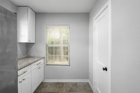 a spacious bathroom with a granite countertop sink and a mirror