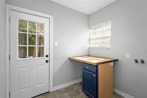 a kitchen with granite countertop white cabinets and window