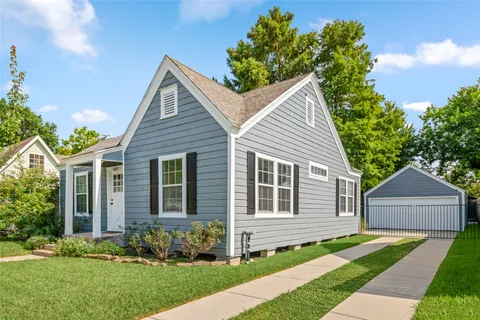a front view of a house with a yard and an outdoor seating