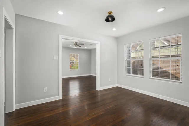 a kitchen with a refrigerator and wooden floor
