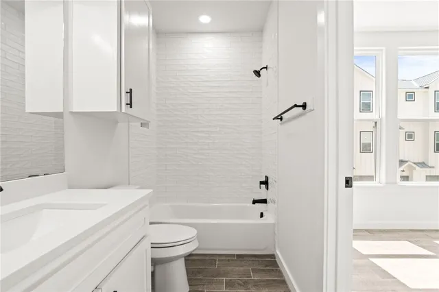 a bathroom with a toilet a sink and bathtub