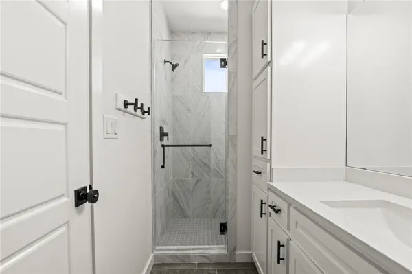a bathroom with a shower and a sink