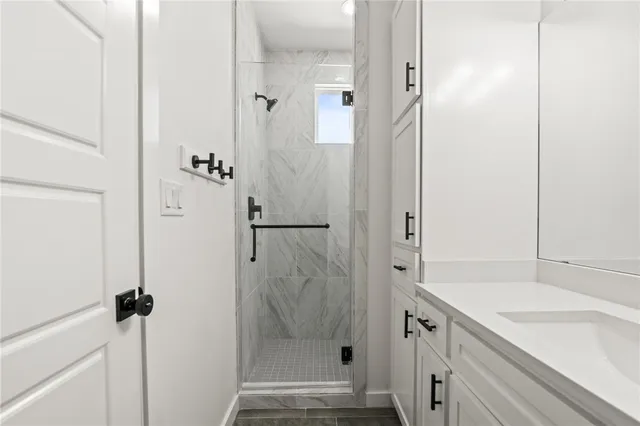 a bathroom with a shower and a sink