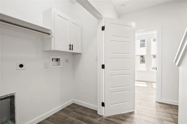 a view of walk in closet with wooden floor