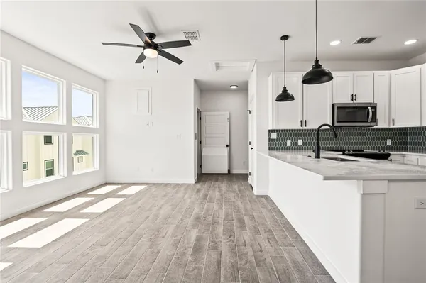 a view of kitchen with sink a microwave and a refrigerator