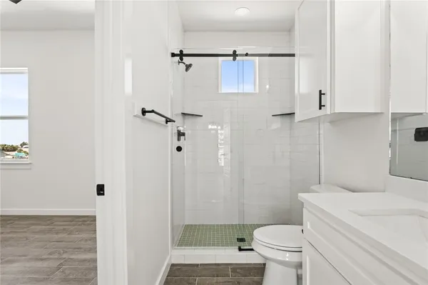 a bathroom with a toilet and a shower
