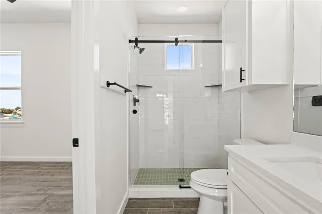 a bathroom with a toilet and a shower