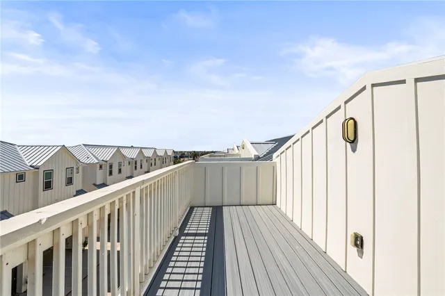 a view of balcony with wooden floor and fence