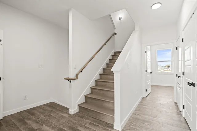 a view of entryway with stairs and wooden floor