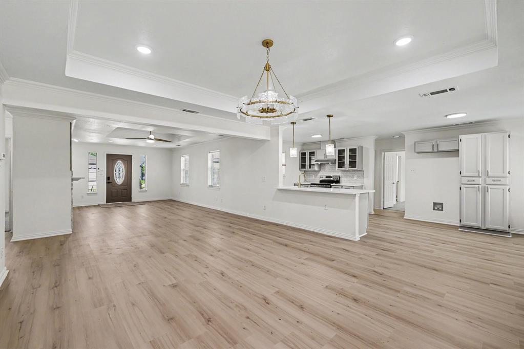 307 Dixon Street Terrell, TX 75160 - Photo 4 of 32 Spacious living area featuring light wood-finish flooring, recessed lighting, and a decorative chandelier