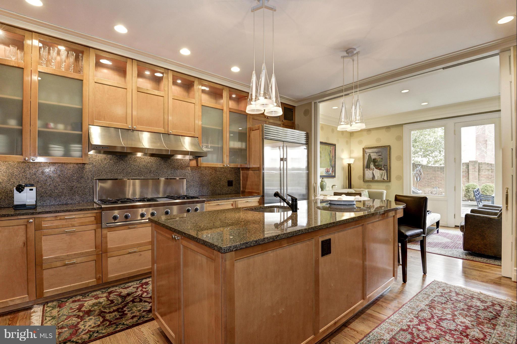 1809 Kalorama Square Washington, DC 20008 - Photo 4 of 27 a kitchen with stainless steel appliances granite countertop a sink a stove and a table