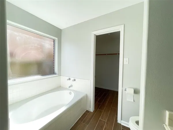 a bathroom with a bathtub and a sink