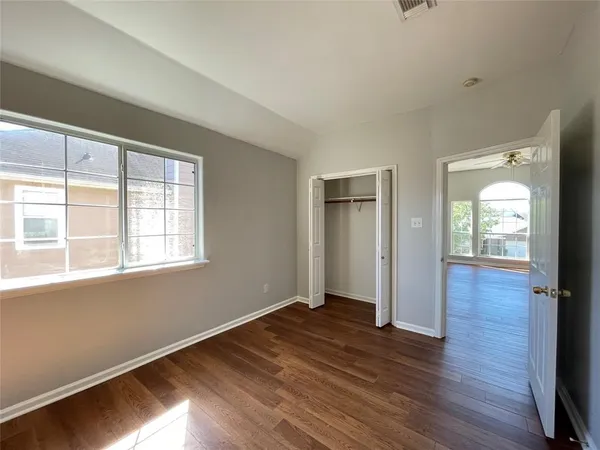 a view of a hallway with wooden floor