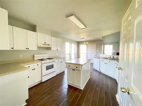 a view of a kitchen cabinets a sink and wooden floor