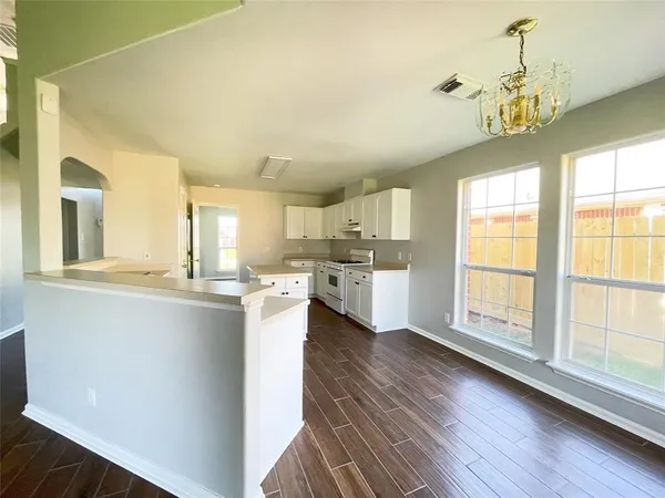 a view of kitchen and wooden floor