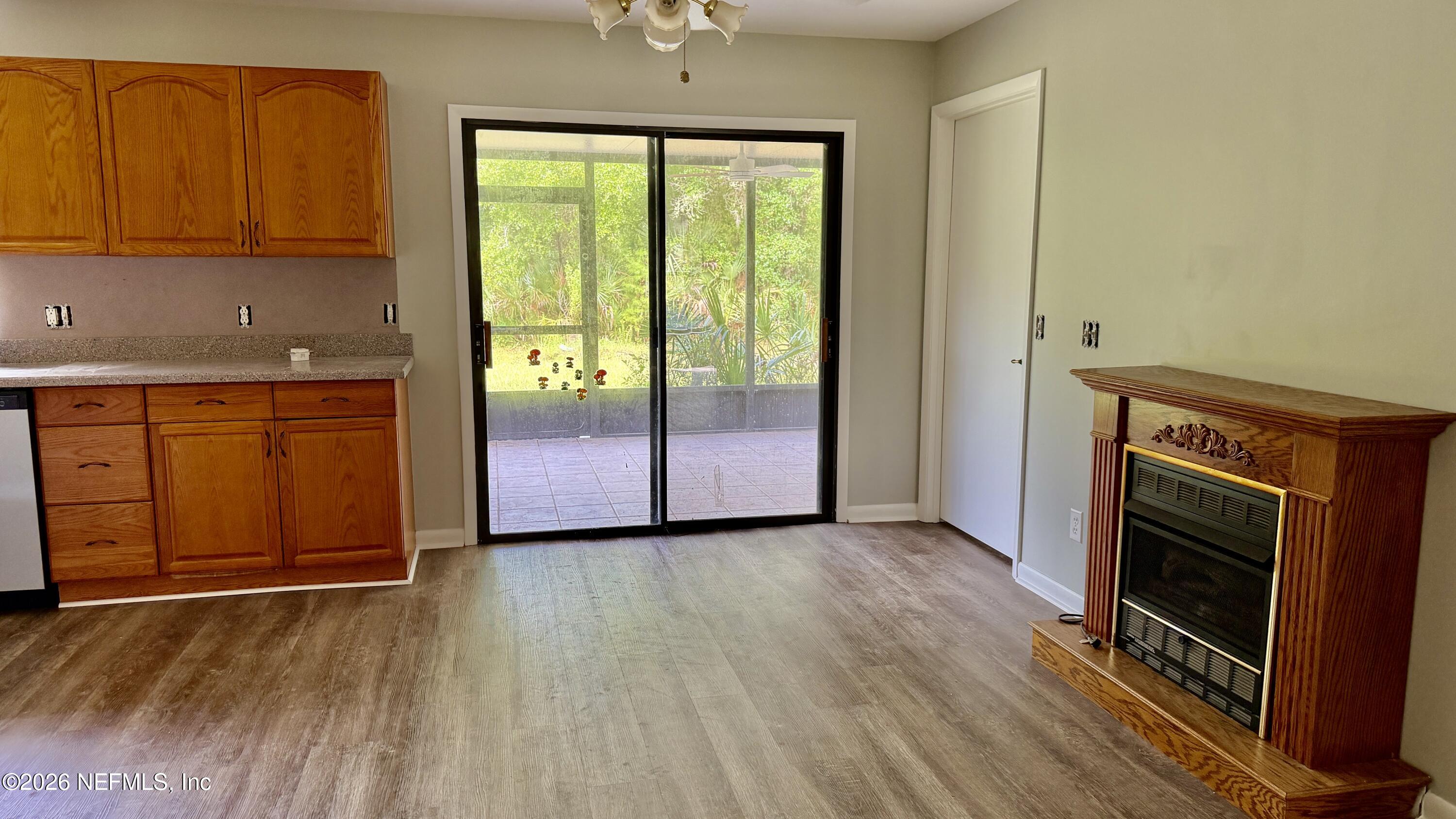 850 Cousintown Road Interlachen, FL 32148 - Photo 9 of 27 an empty room with wooden floor cabinet and front door