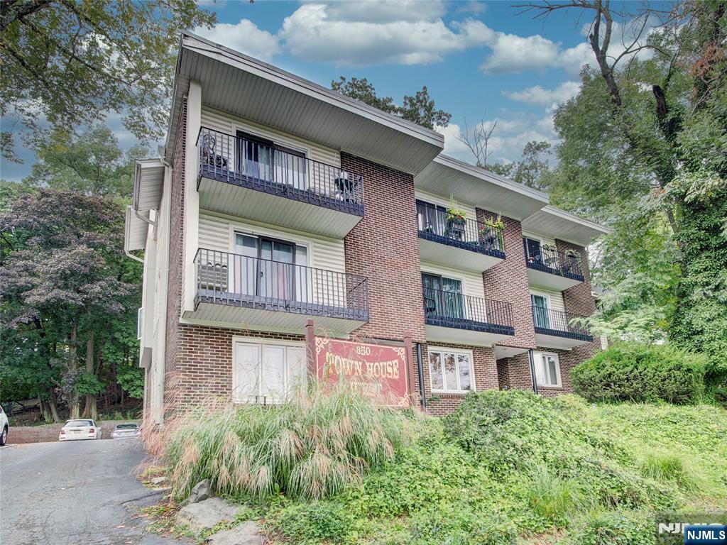 a front view of a building with a garden