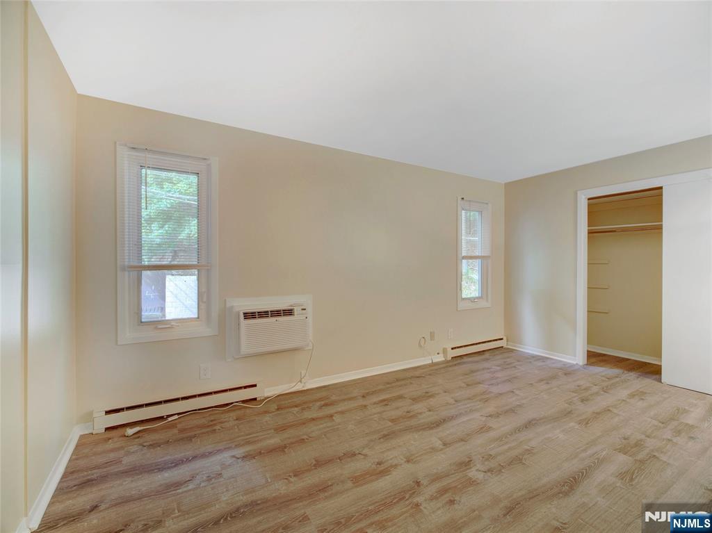 850 Bloomfield Avenue, Unit A3 Montclair, NJ 07042 - Photo 13 of 14 a view of an empty room with wooden floor and a window