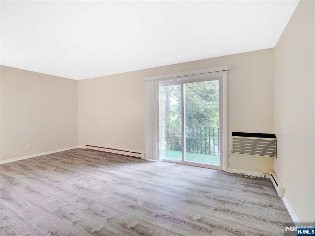 850 Bloomfield Avenue, Unit A3 Montclair, NJ 07042 - Photo 8 of 14 an empty room with wooden floor and windows