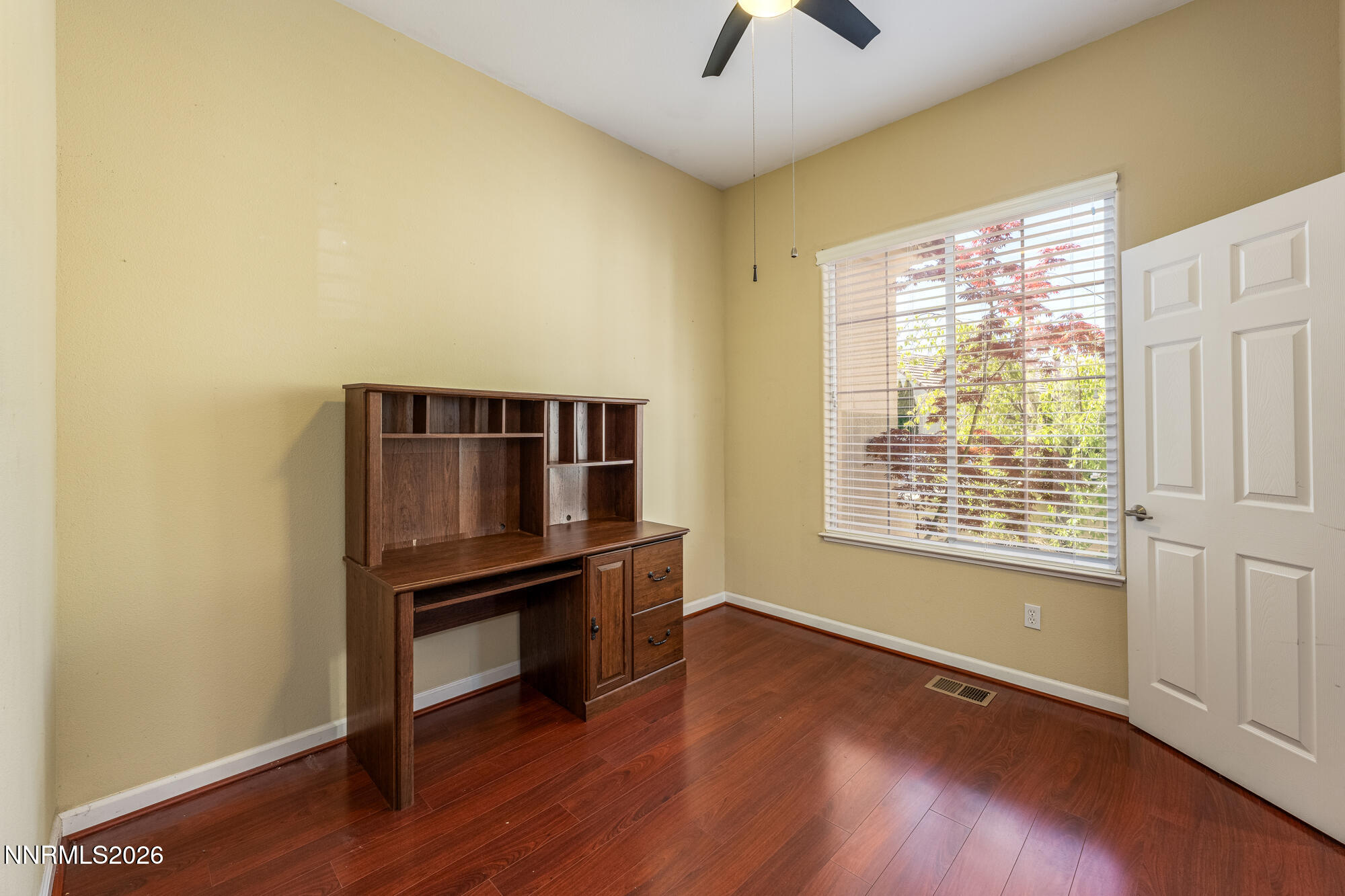 1840 Hunter Creek Road Reno, NV 89519 - Photo 22 of 39 a view of an empty room with wooden floor and a window