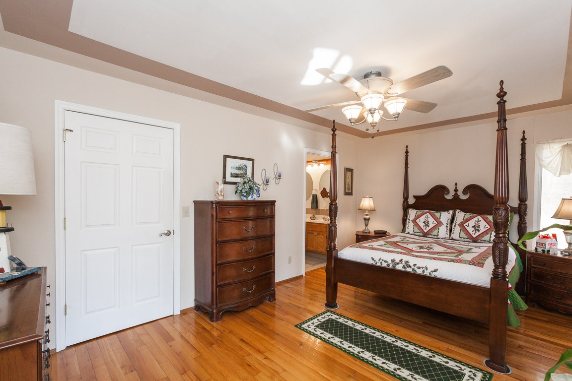 3155 Rocky Point Road Stewart, TN 37175 - Photo 17 of 44 a bedroom with a bed and a chandelier