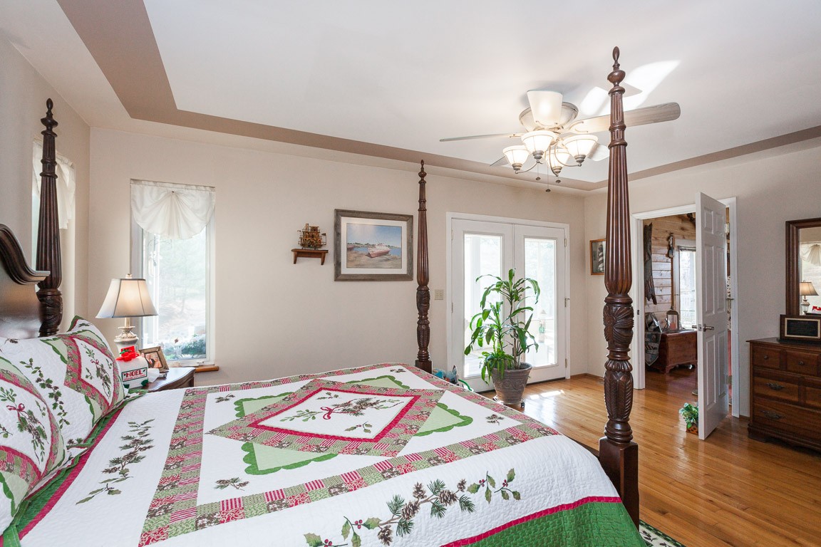 3155 Rocky Point Road Stewart, TN 37175 - Photo 18 of 44 a bed room with a bed mirror and a chair