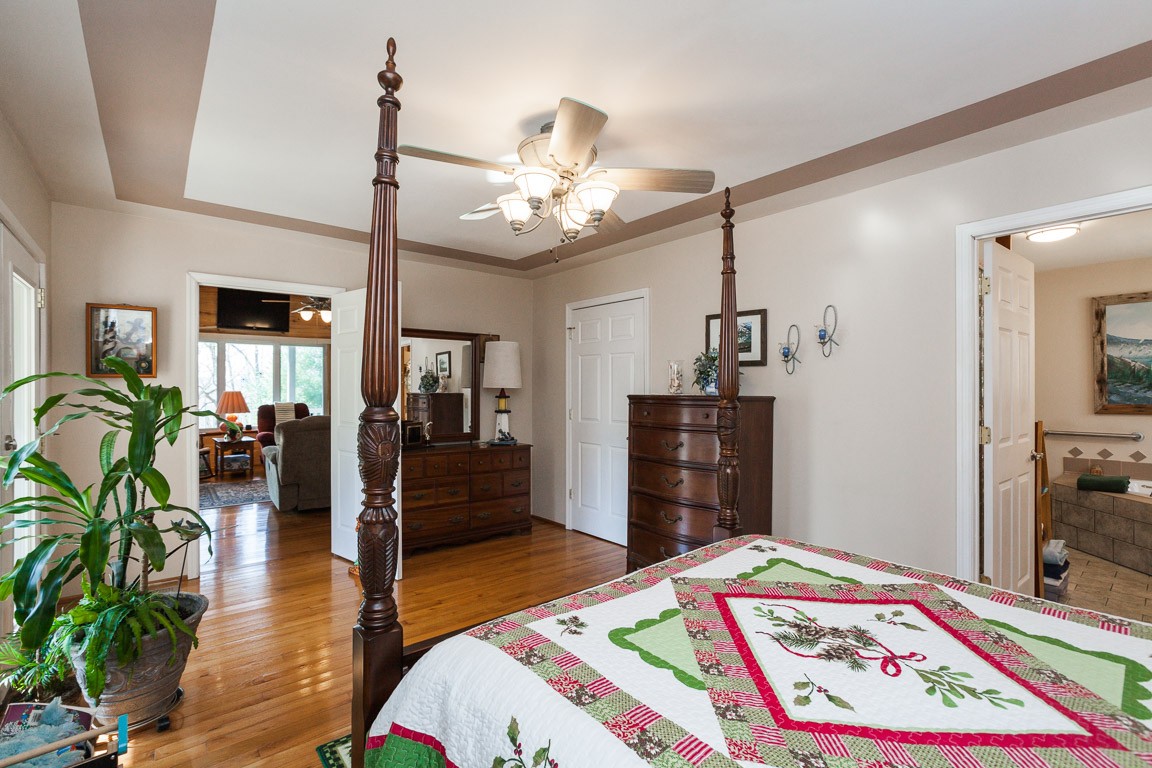 3155 Rocky Point Road Stewart, TN 37175 - Photo 19 of 44 a bedroom with a bed and a chandelier