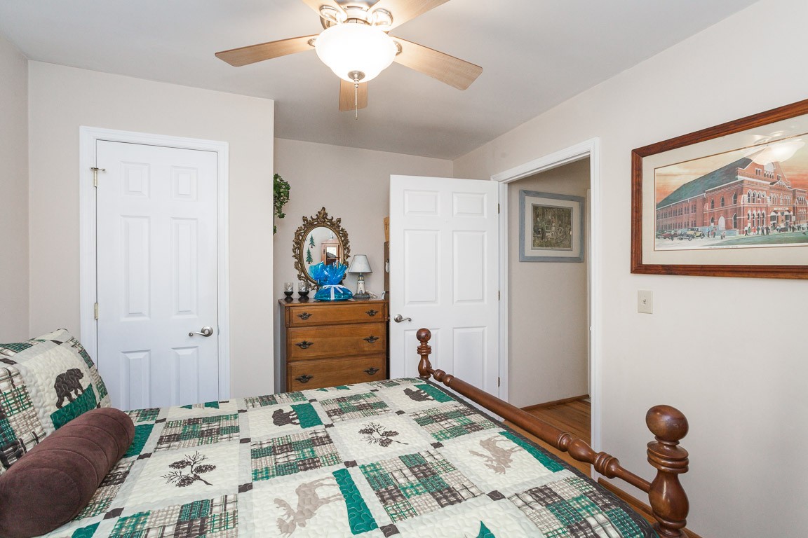 3155 Rocky Point Road Stewart, TN 37175 - Photo 24 of 44 a bed room with a bed and a chandelier