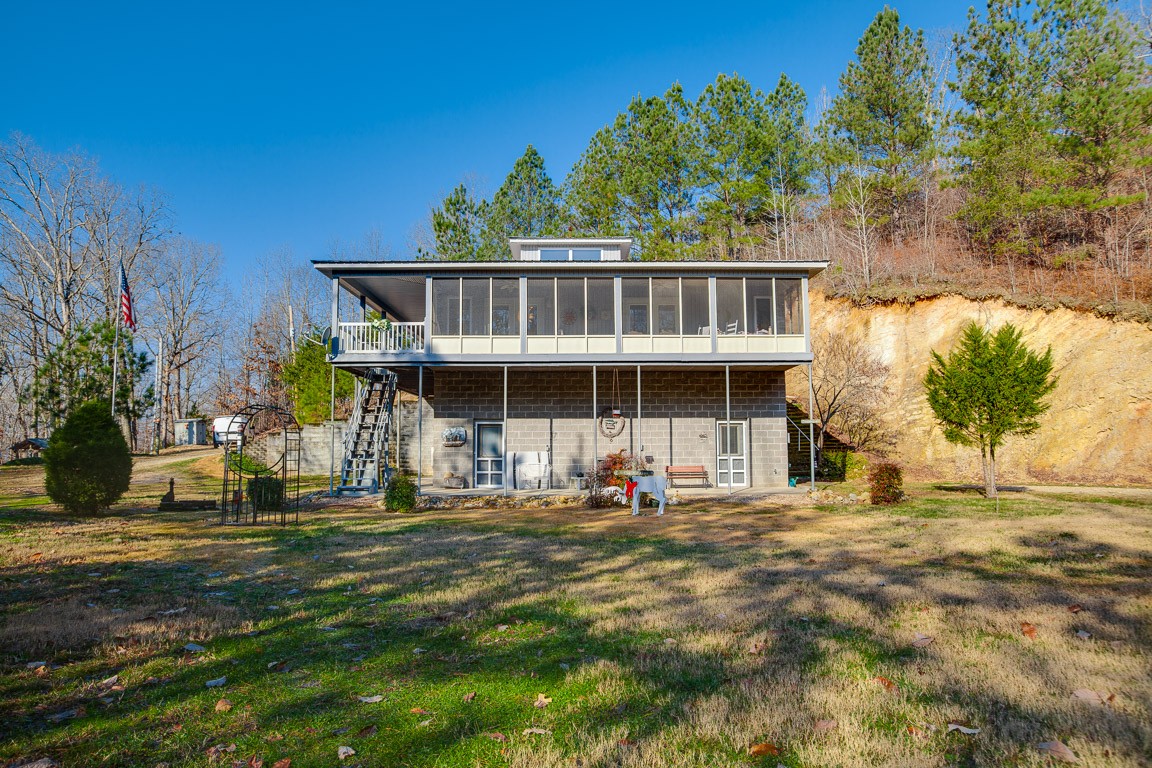 3155 Rocky Point Road Stewart, TN 37175 - Photo 33 of 44 a front view of a house with a garden