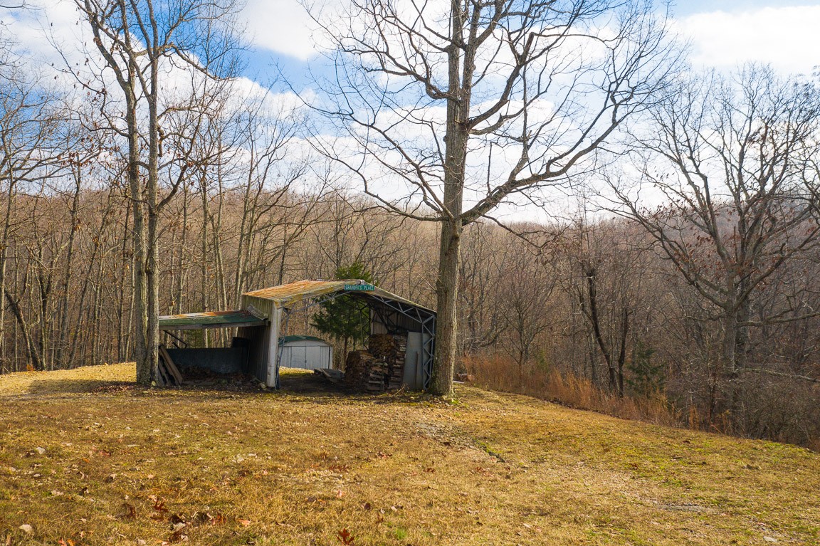 3155 Rocky Point Road Stewart, TN 37175 - Photo 37 of 44 a backyard of a house with fire pit and trees