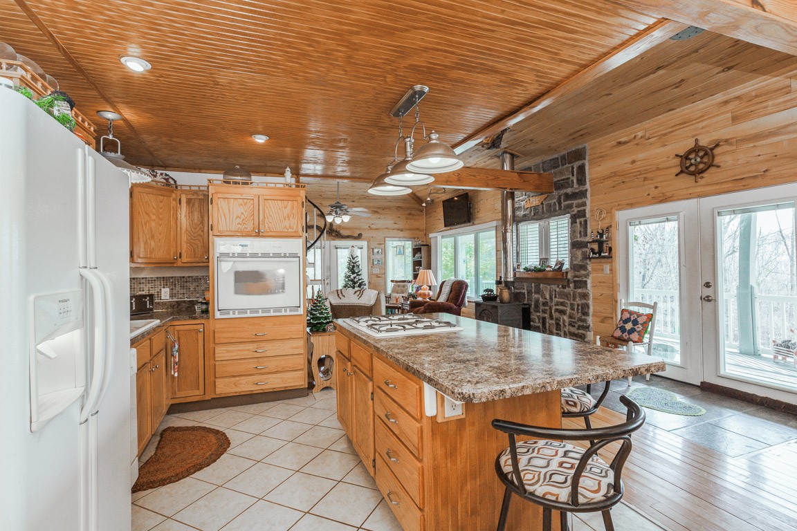 3155 Rocky Point Road Stewart, TN 37175 - Photo 9 of 44 a kitchen with stainless steel appliances granite countertop a sink and cabinets