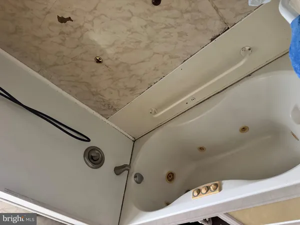 a bathroom with a tub and a shower