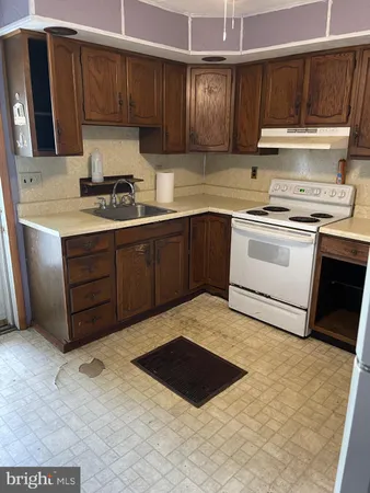 a kitchen with a cabinets and white appliances
