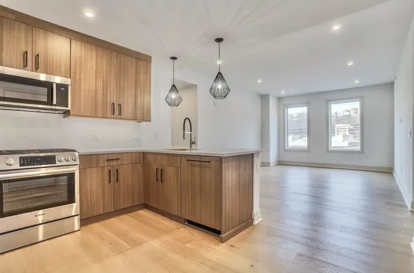 a kitchen with stainless steel appliances a stove microwave and sink