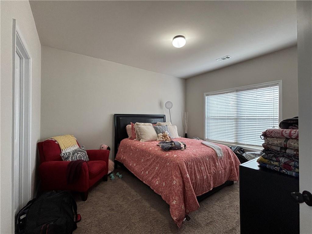3459 In Bloom Way Auburn, GA 30011 - Photo 13 of 35 a bedroom with a bed and wooden floor