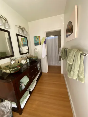 a utility room with wooden floor washer and dryer