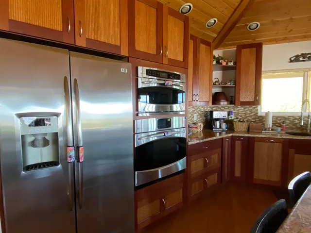 a kitchen with stainless steel appliances granite countertop a refrigerator a sink and dishwasher