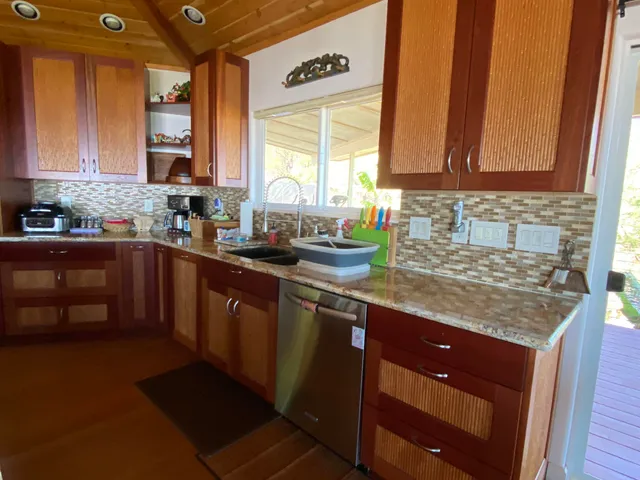 a kitchen with stainless steel appliances granite countertop a sink stove and cabinets