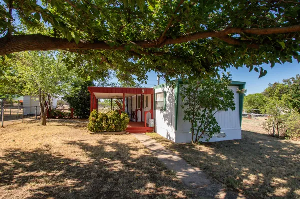 a view of a house with large tree