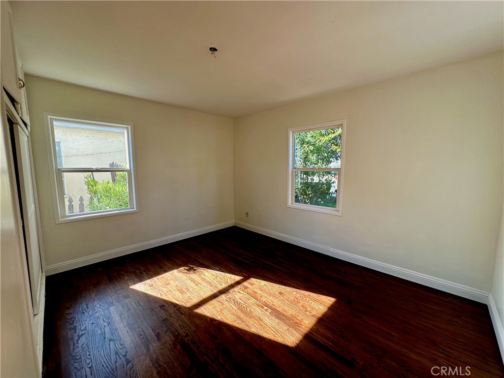 291 North Main Street Orange, CA 92868 - Photo 6 of 20 an empty room with wooden floor and windows
