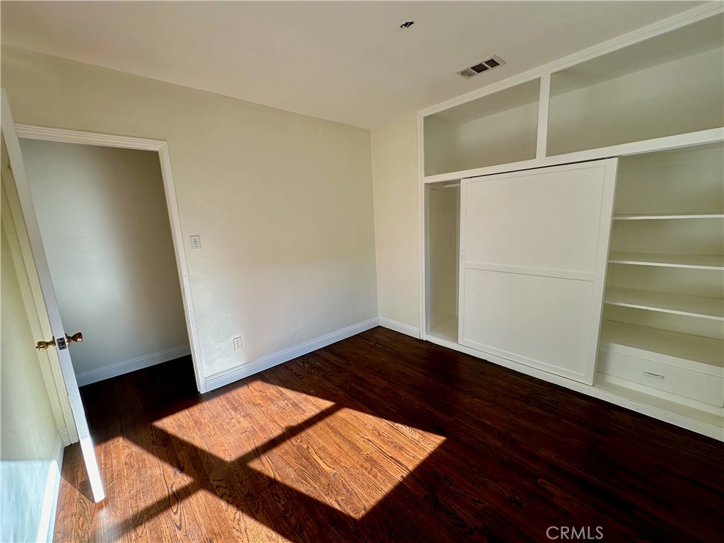 291 North Main Street Orange, CA 92868 - Photo 7 of 20 an empty room with wooden floor