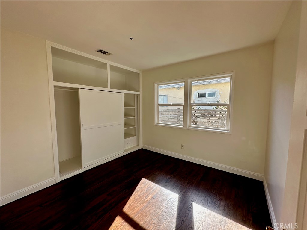 291 North Main Street Orange, CA 92868 - Photo 8 of 20 a view of an empty room with wooden floor and a window