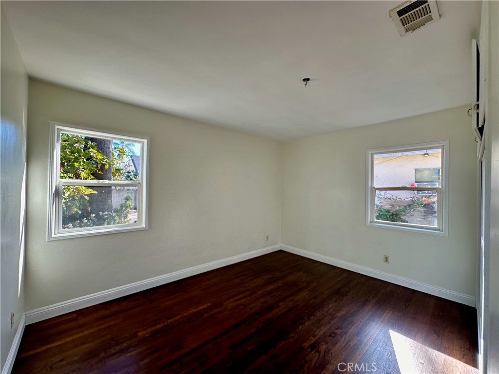 291 North Main Street Orange, CA 92868 - Photo 10 of 20 a view of an empty room with wooden floor and a window