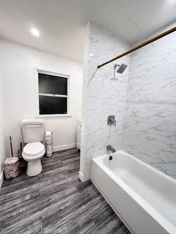 a bathroom with a toilet a sink and bathtub