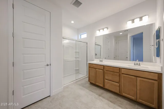 a bathroom with a double vanity sink and a mirror